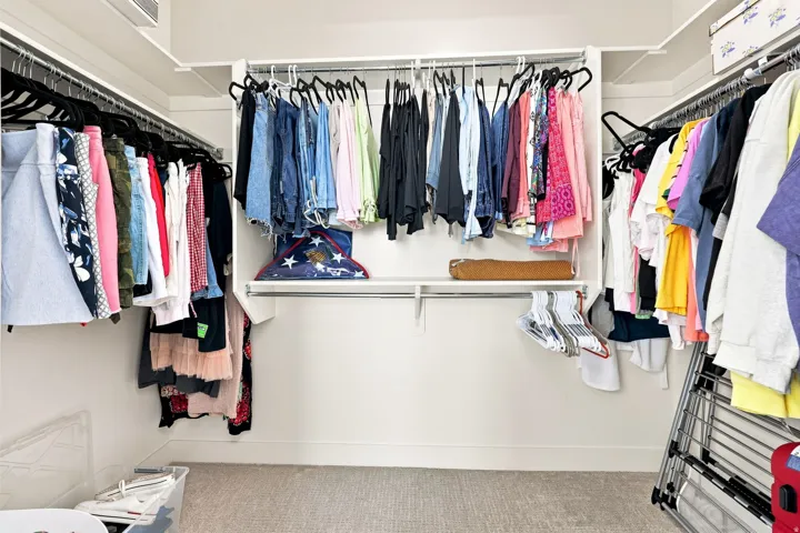 Walk-in closet with carpet flooring, white walls, and built-in white shelving