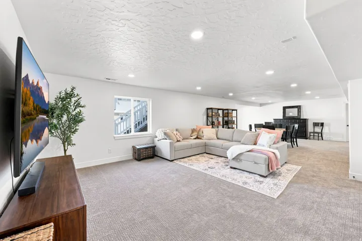 Expansive recreation area featuring recessed lighting, a window, and durable carpeting