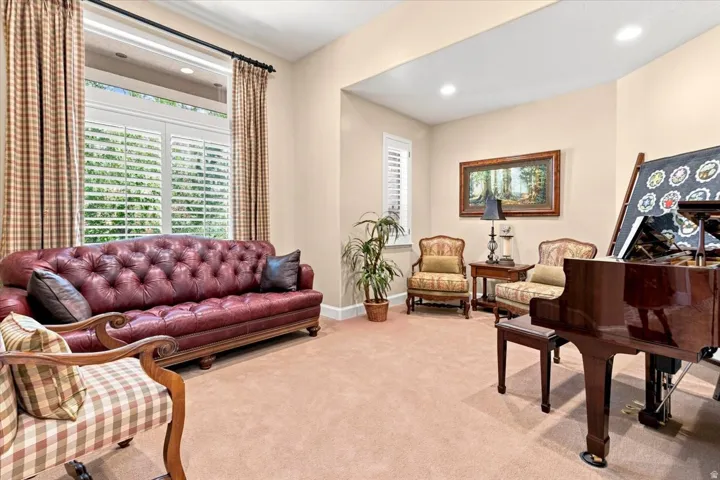 Recessed lighting, crown molding, plantation shutters, large windows, and neutral wall tones