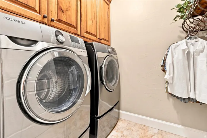 Built-in wood cabinetry, full-size front-load washer and dryer, and tiled flooring