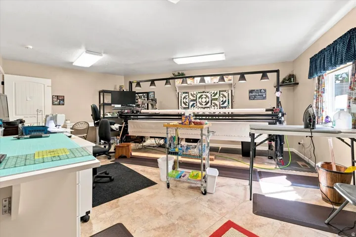 Recessed lighting, tile flooring, window with valance and curtains, built-in shelving, and neutral wall paint