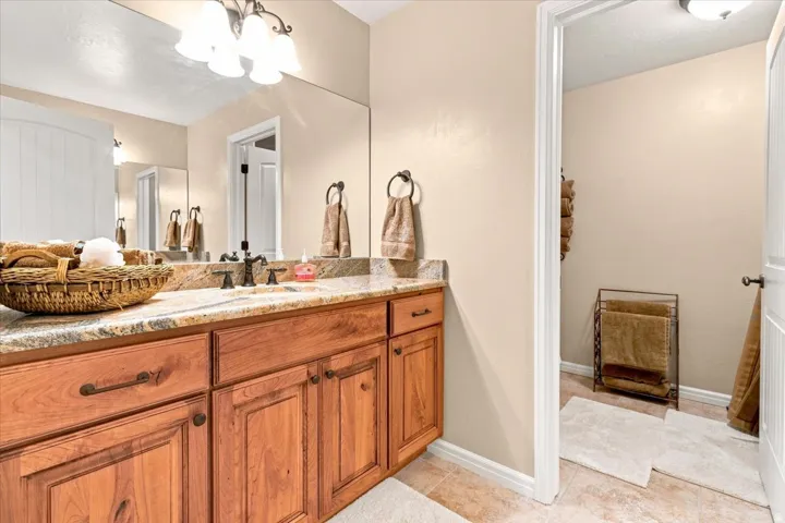 Wood-finish vanity with granite countertop and undermount sink