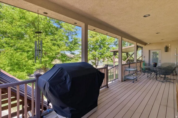 Covered outdoor deck with composite decking, recessed lighting, and direct access to interior space
