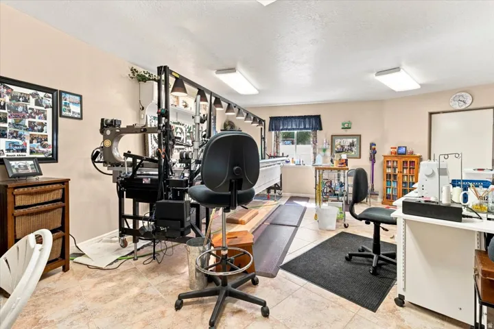 Tile flooring, neutral wall paint, recessed lighting, window with privacy blinds, built-in shelving