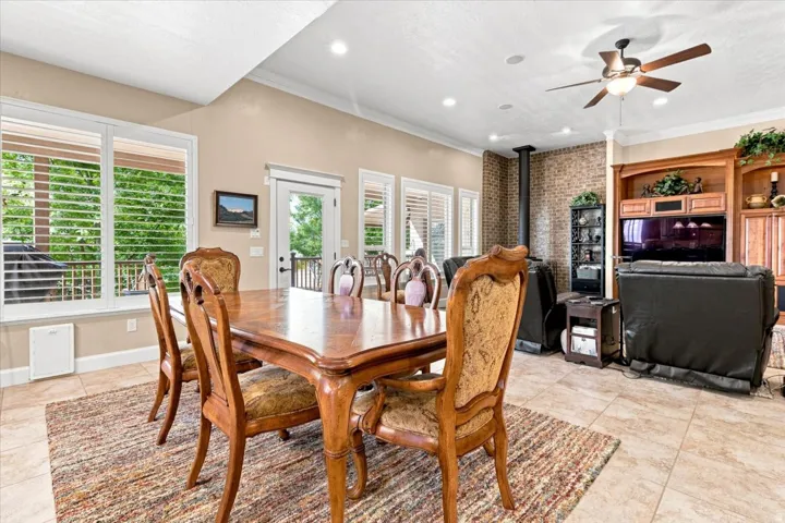 Spacious open-concept living area featuring tile flooring, recessed lighting, and a ceiling fan