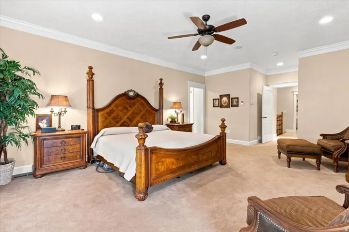 Spacious room featuring carpeting, recessed lighting, crown molding, and a ceiling fan
