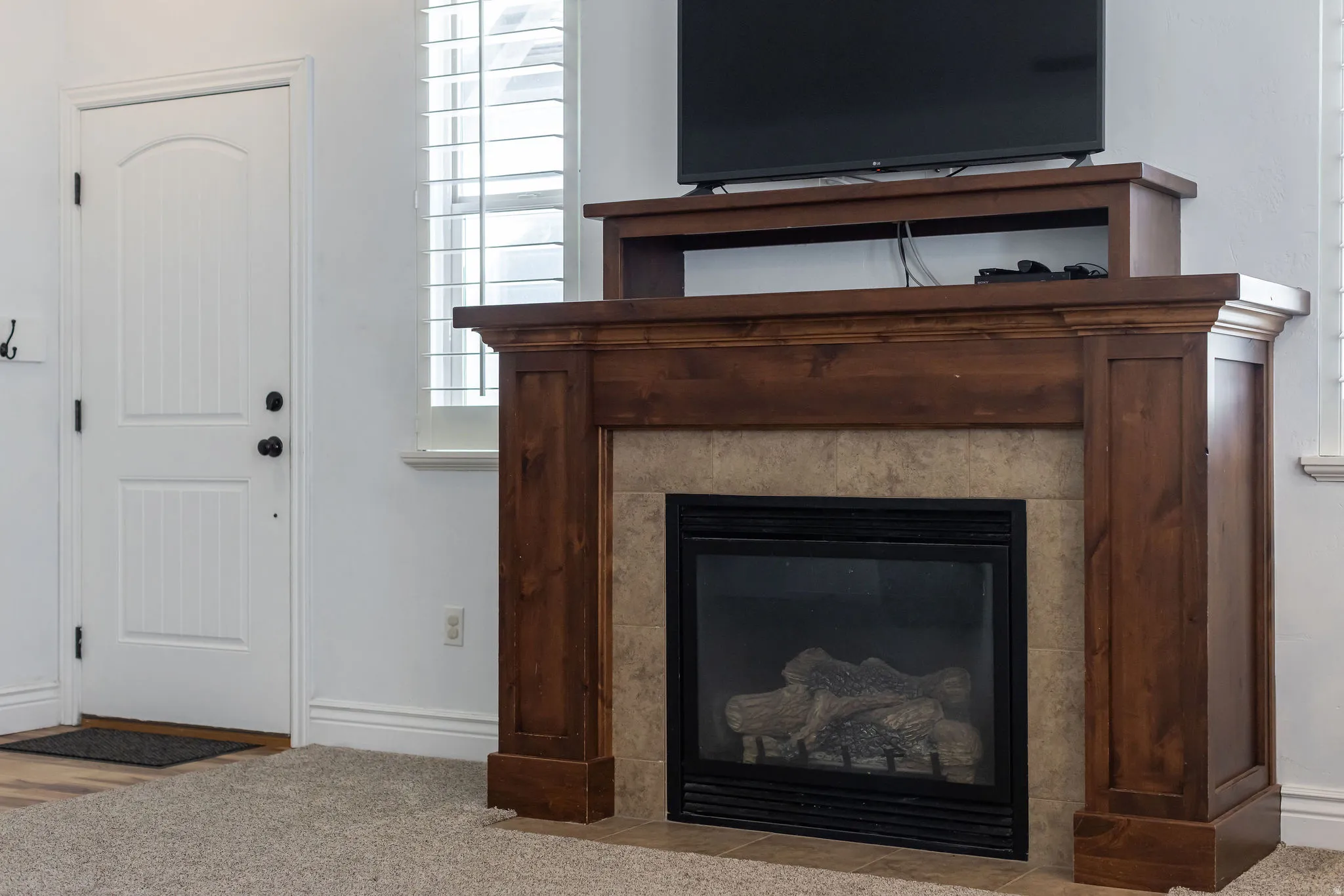 Gas fireplace with a wood-finish mantel