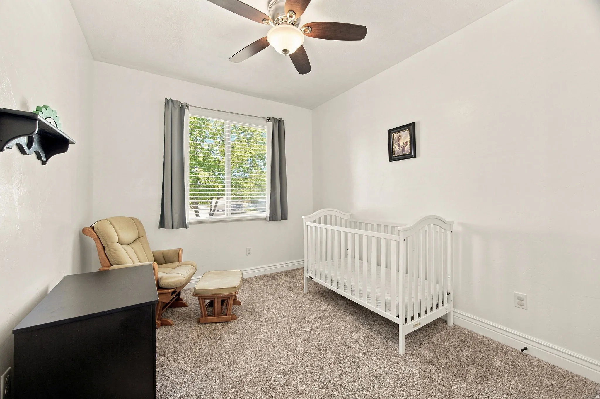 Room featuring a ceiling fan with integrated lighting, a window with blinds, and neutral carpeting