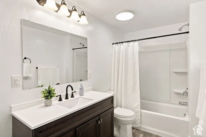 Dark wood-finish vanity with white countertop and integrated sink