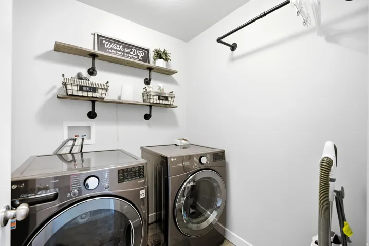 Built-in shelving with wood-finish planks and pipe supports, integrated hanging rod, and light-colored walls