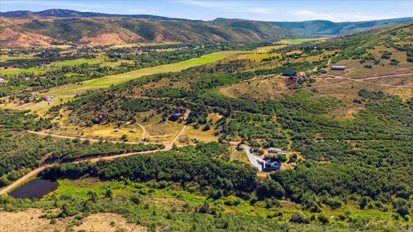 Expansive natural landscape featuring rolling hills and abundant trees