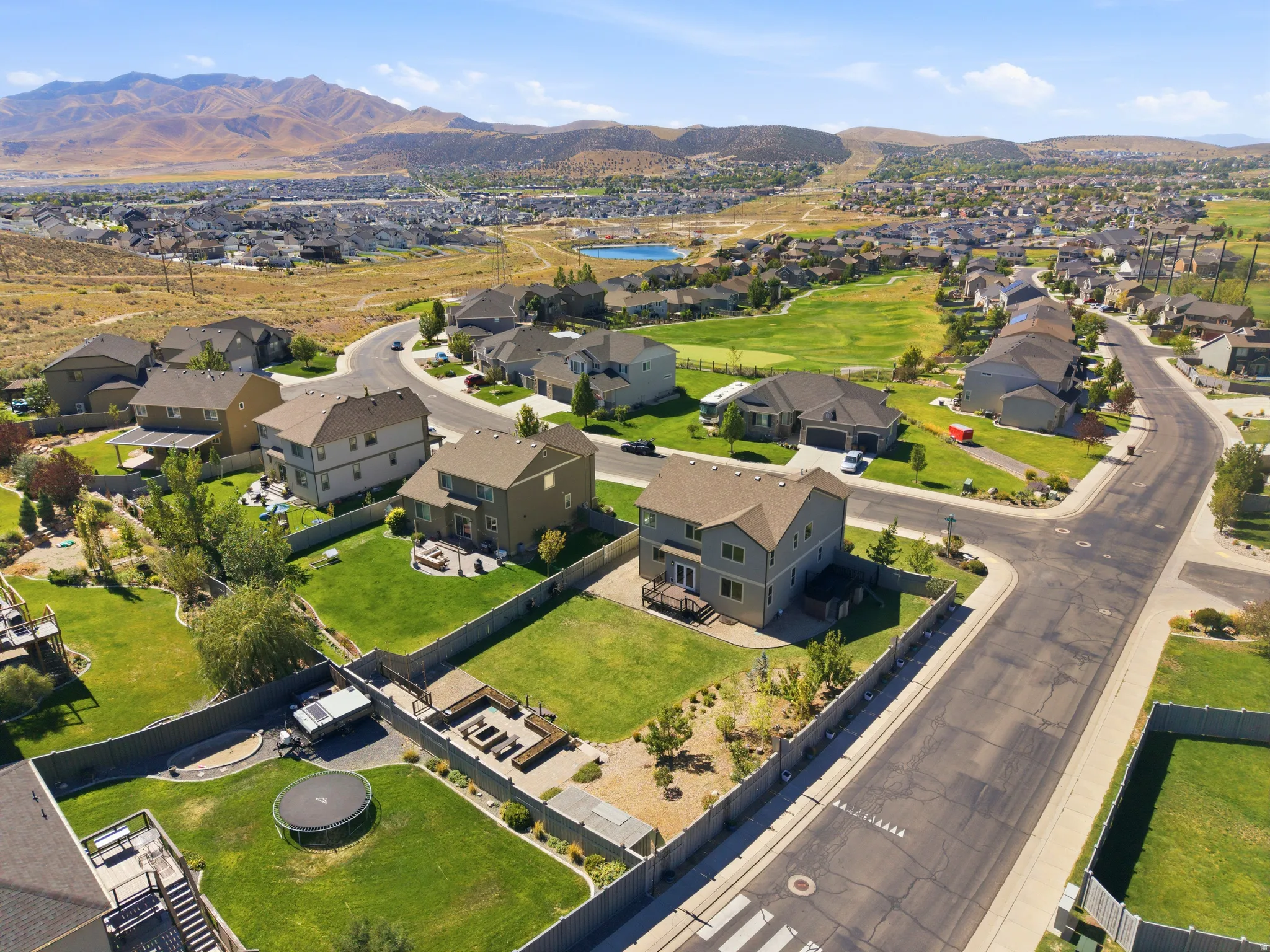 Expansive community featuring residential properties, paved streets, and a mountainous backdrop