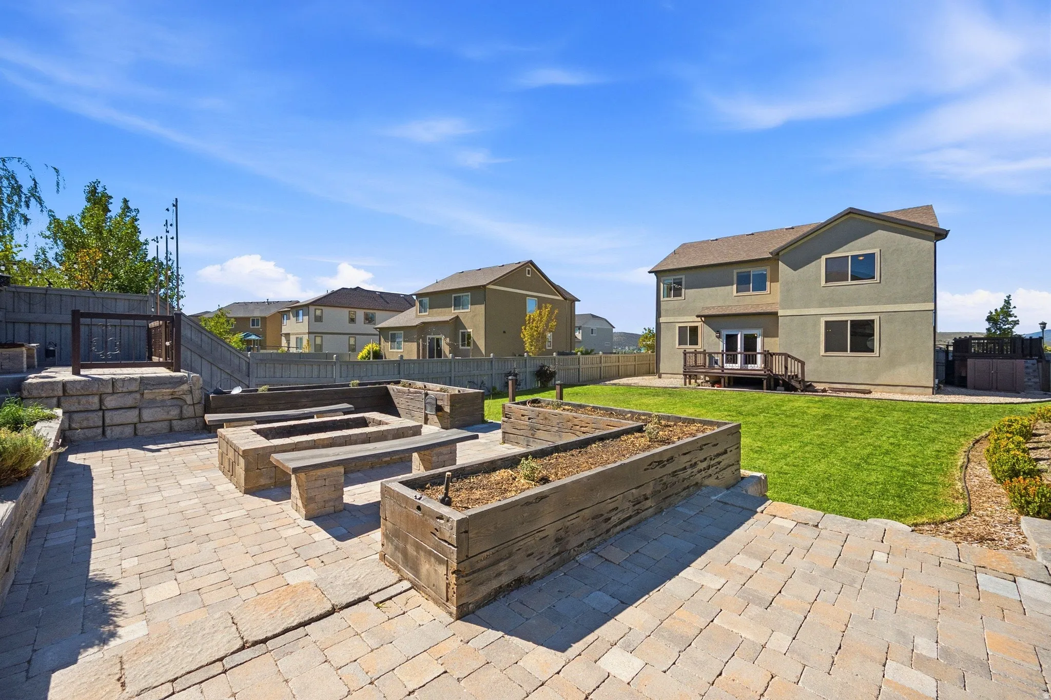 Expansive paver patio with built-in bench seating and planters