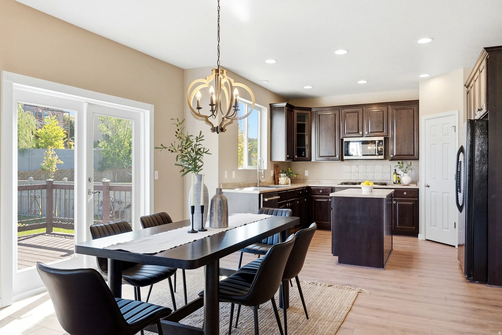 Gourmet kitchen with dark wood cabinetry, stainless steel appliances, and a central island