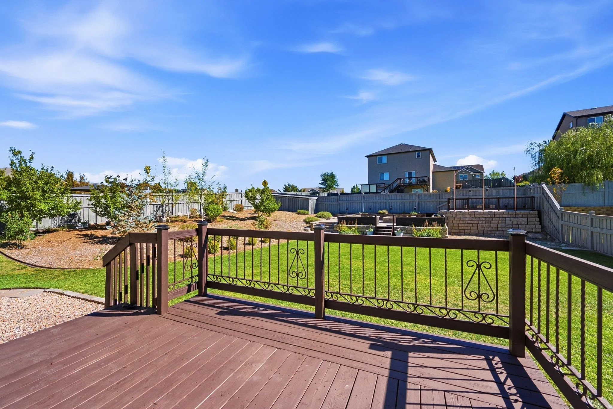 Expansive wood-finish deck with decorative metal railing