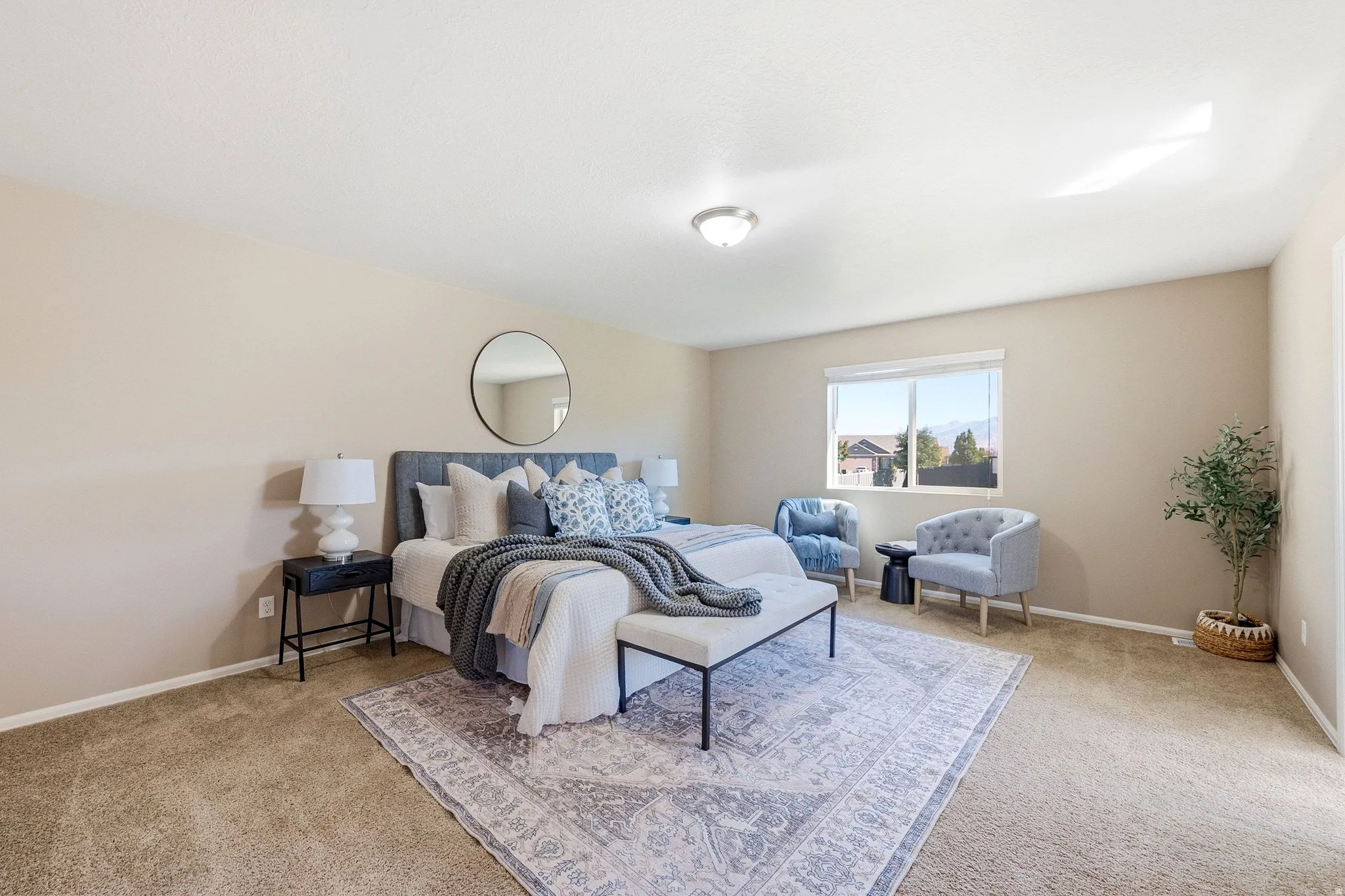 Spacious room with carpeted flooring, a large window, and a flush-mount ceiling light
