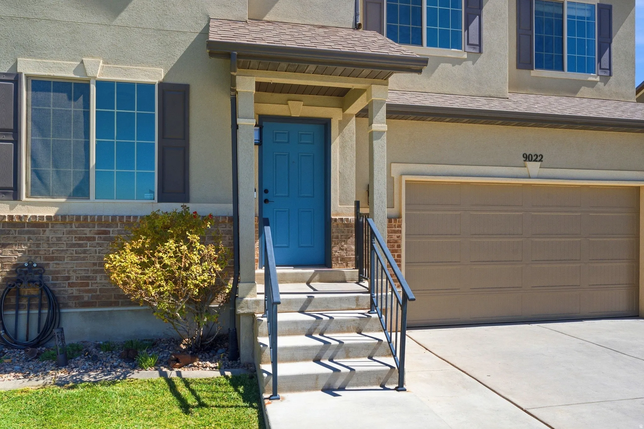 Stucco exterior with brick detailing