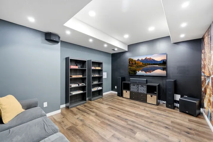 Recessed lighting, wood-finish flooring, and built-in shelving units