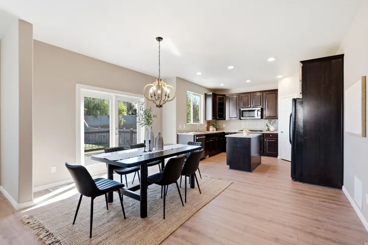 Wood-finish flooring throughout, with a contemporary chandelier in the dining area