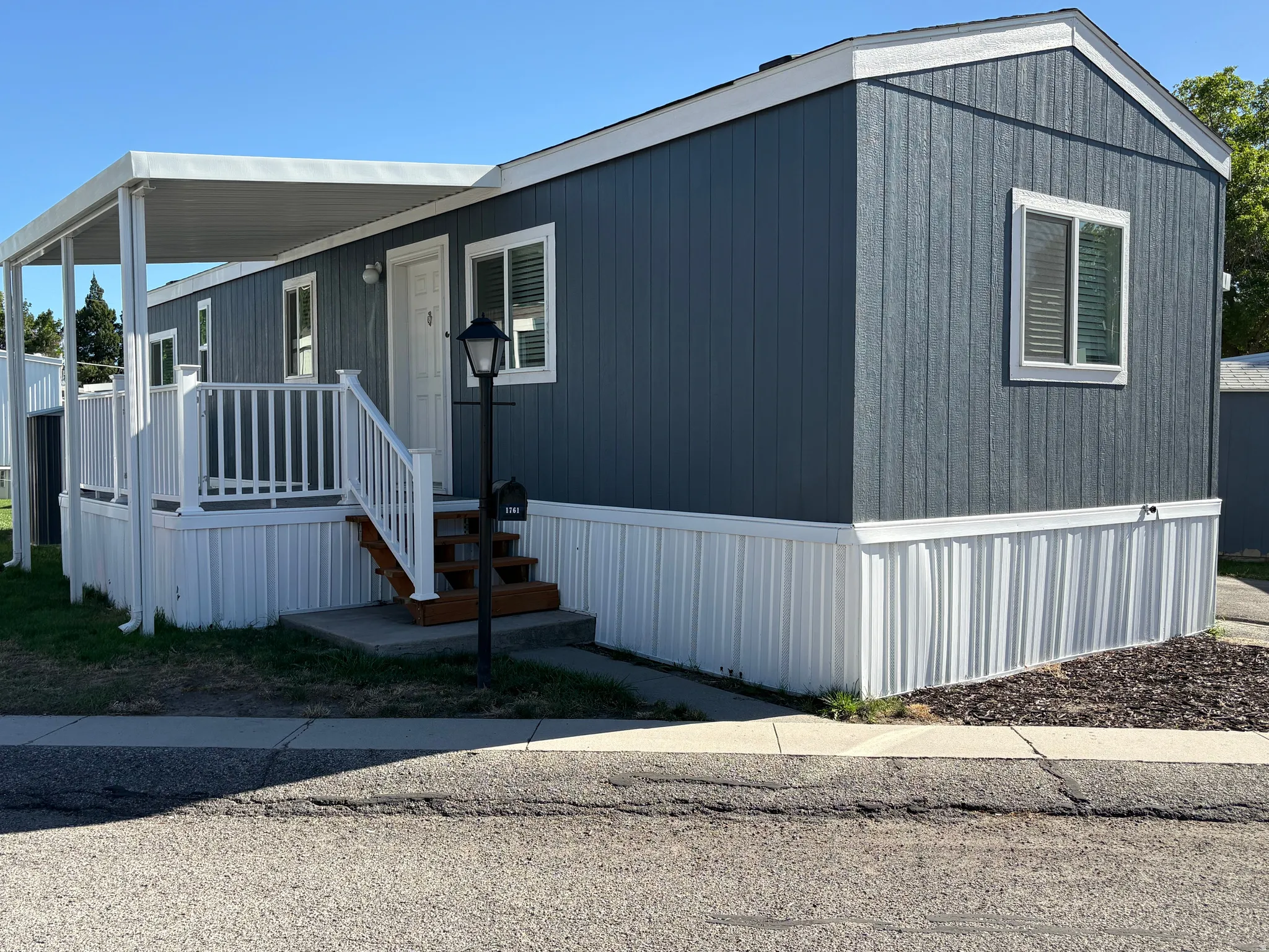 Blue vertical siding exterior with white trim