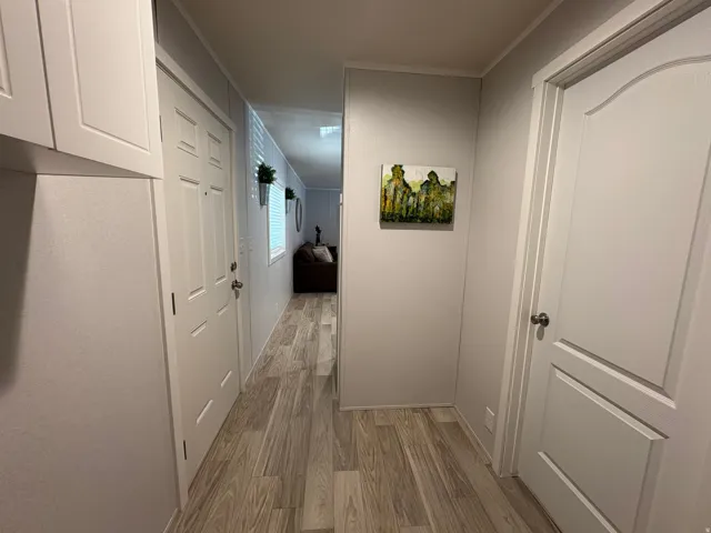 Light wood-finish flooring extending through the hallway