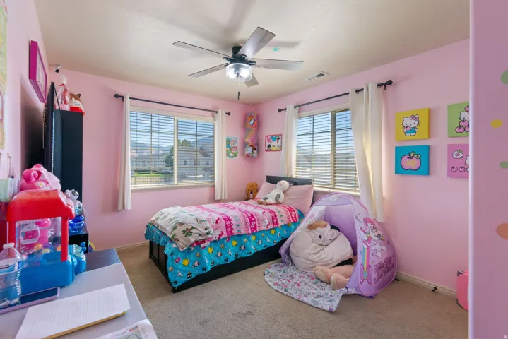 Double windows with horizontal blinds and white drapes
