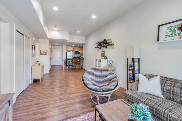 Recessed lighting throughout, wood-finish flooring, and white walls