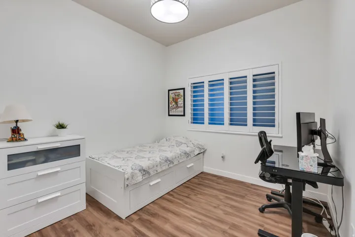 Wood-finish flooring, white walls, and a contemporary ceiling light fixture