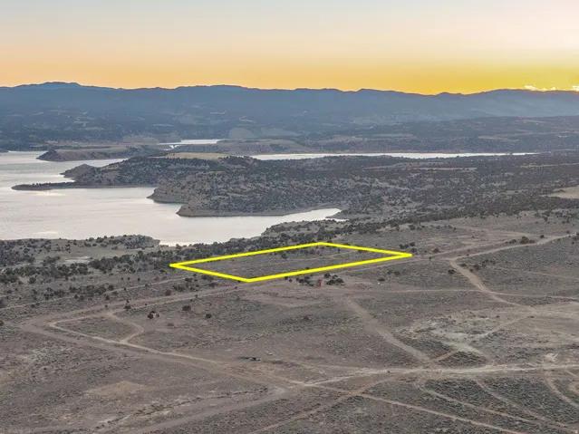 Expansive land parcel featuring natural terrain and distant water bodies