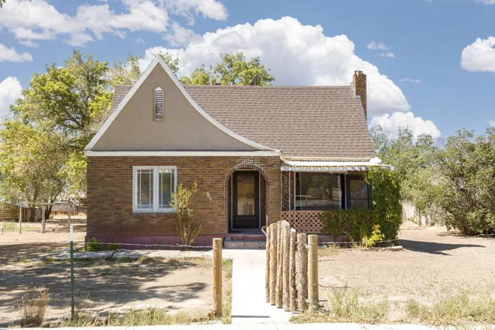 Brick exterior with stucco gables, arched entry, and a covered porch