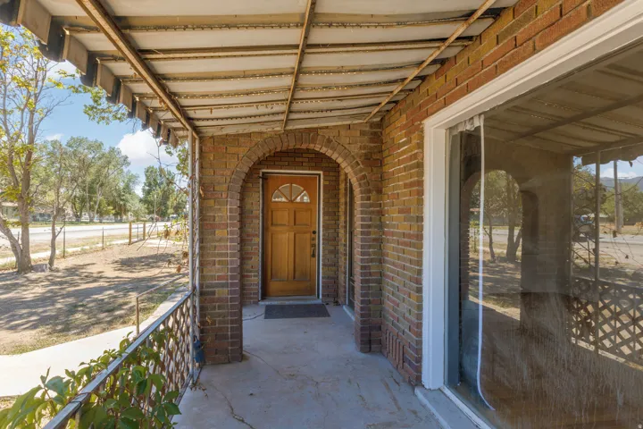 Brick exterior with an arched entryway and covered porch