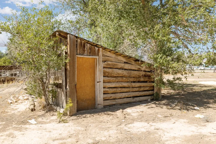 Wood-sided shed with a sloped metal roof
