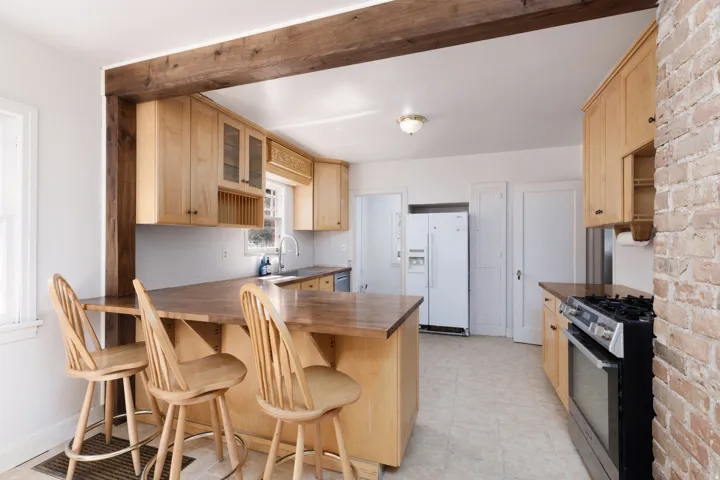 Exposed brick accent wall and wood beam detailing