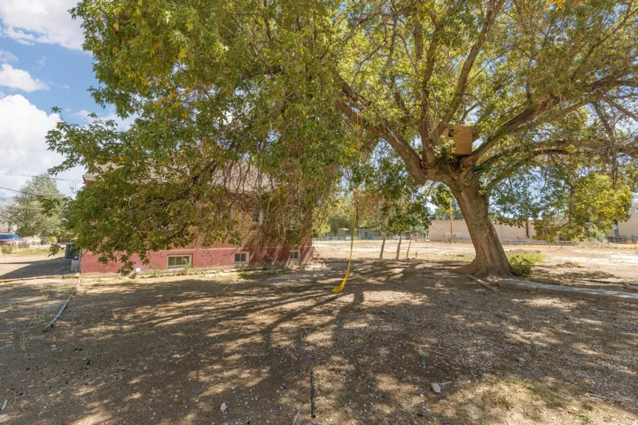 Expansive property featuring mature trees and a substantial red brick exterior