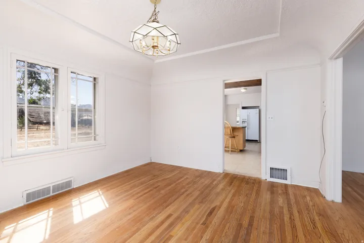 Hardwood flooring, dual pane windows, and a ceiling-mounted light fixture