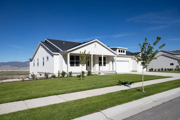 Our farmhouse rambler with large covered porch, view from southeast corner of the .75 acre property.