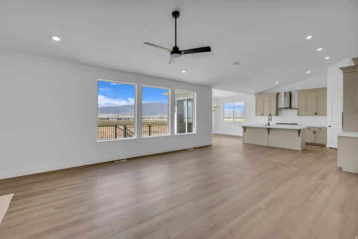View from great room into kitchen and dining rooms.  Large custom pictures windows with spectacular mountain views.