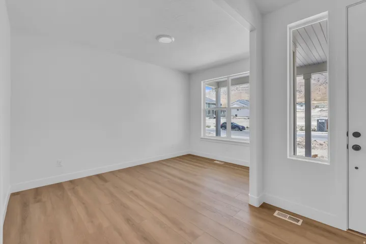 View from entry into flex space with beautiful hard flooring and large windows with beautiful mountain views.