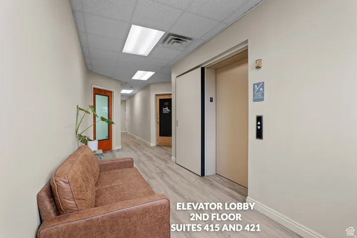 Recessed lighting, wood-finish flooring, drop ceiling, and elevator access