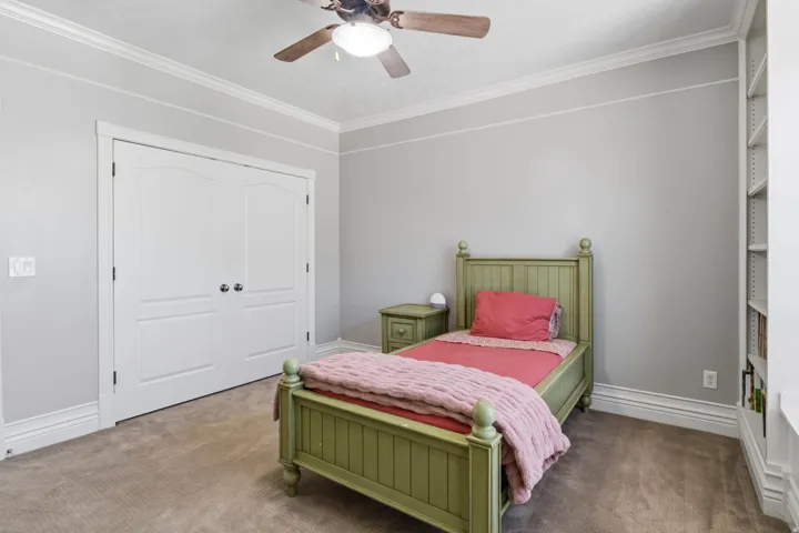 Recessed lighting, crown molding, double bi-fold doors, built-in shelving, and carpet flooring