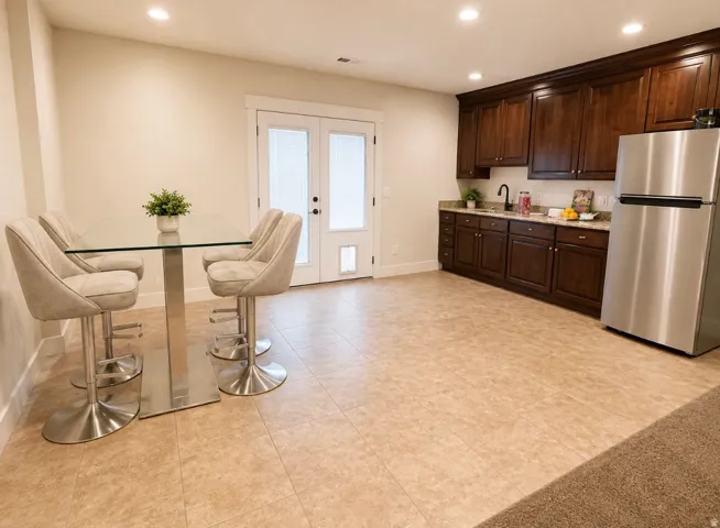 Wet bar with granite countertops and dark wood cabinetry