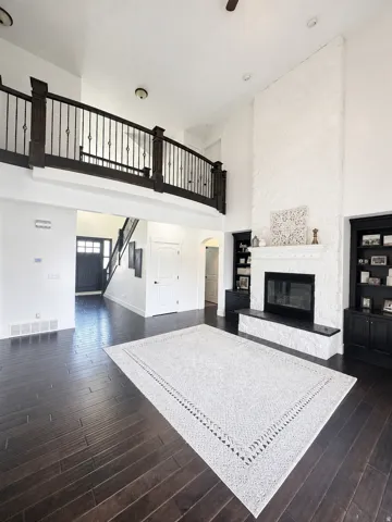 Two-story living area with dark wood-finish flooring