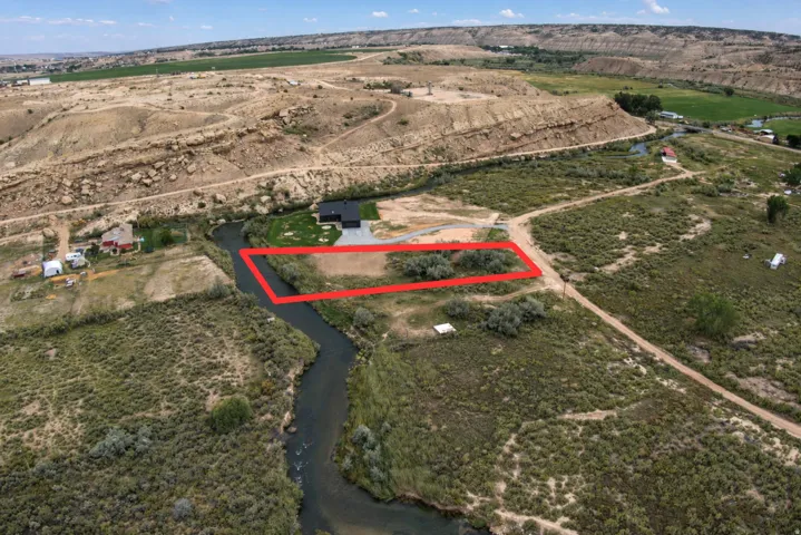Riverside lot with natural landscaping and mature trees