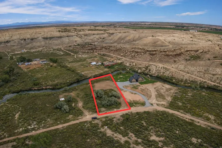 Expansive lot featuring mature trees and direct access to a natural watercourse