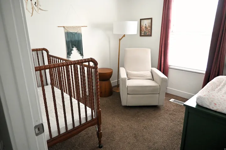 Carpeted room with a window, white walls, and white trim