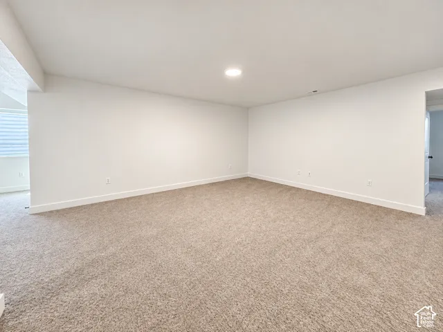 Recessed lighting, light-toned carpeting, white walls, and white trim