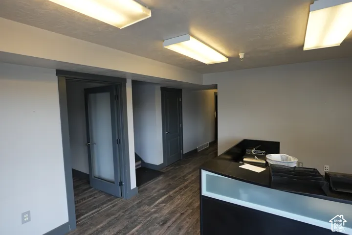 Wood-finish flooring, recessed lighting, solid core doors, built-in counter, and modern light fixtures