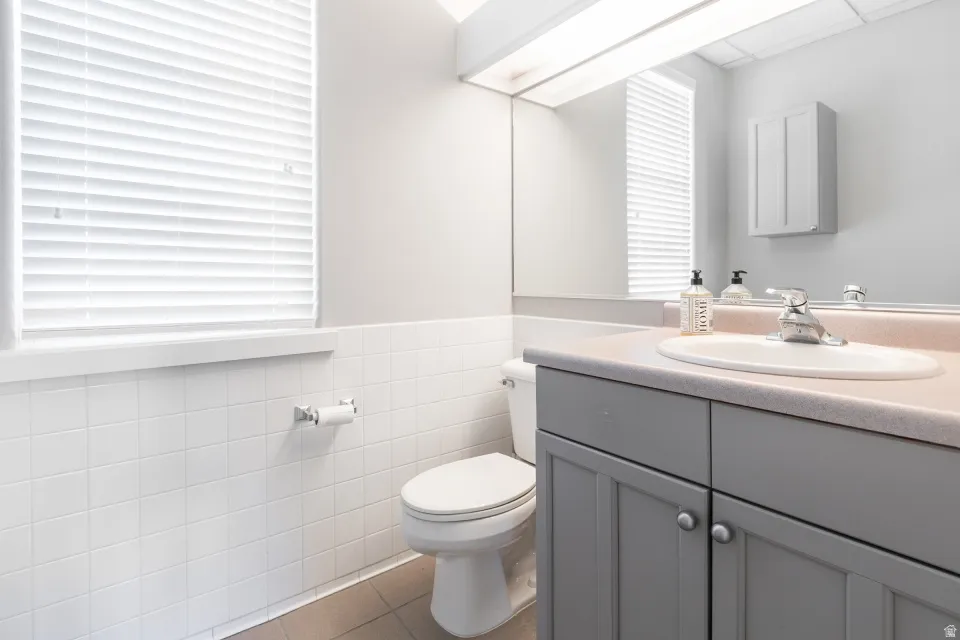 Vanity with an integrated sink, dual-door base cabinet, and a wall-mounted medicine cabinet