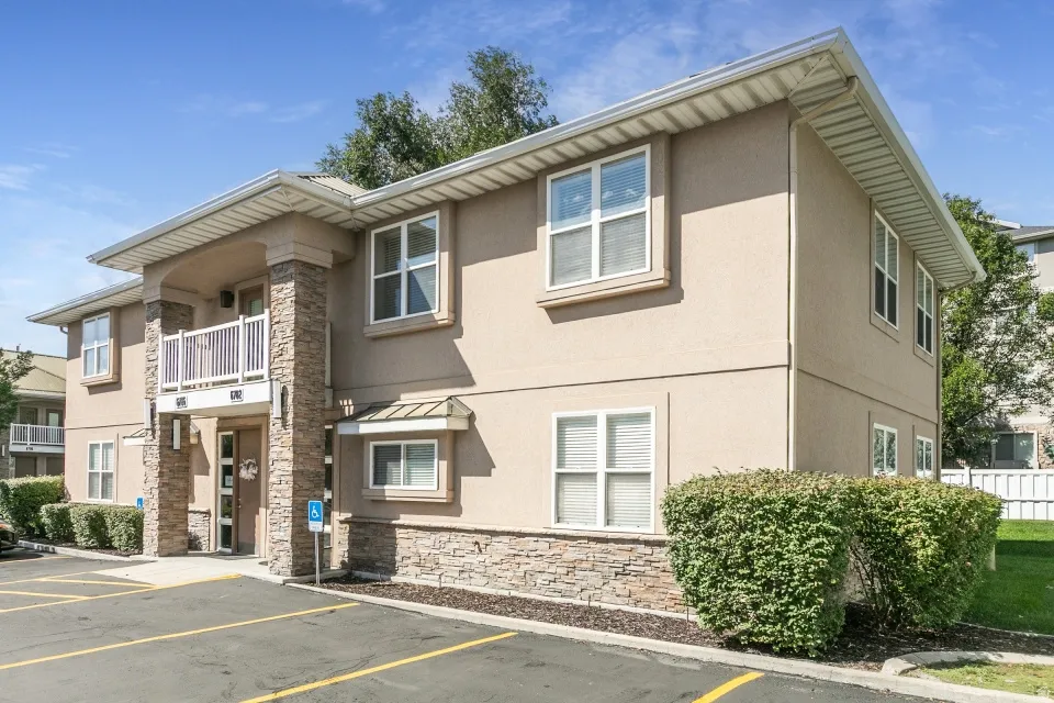 Two-story exterior with stucco finish and stone veneer accents