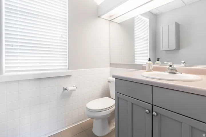 Vanity with an integrated sink, dual-door base cabinet, and a wall-mounted medicine cabinet